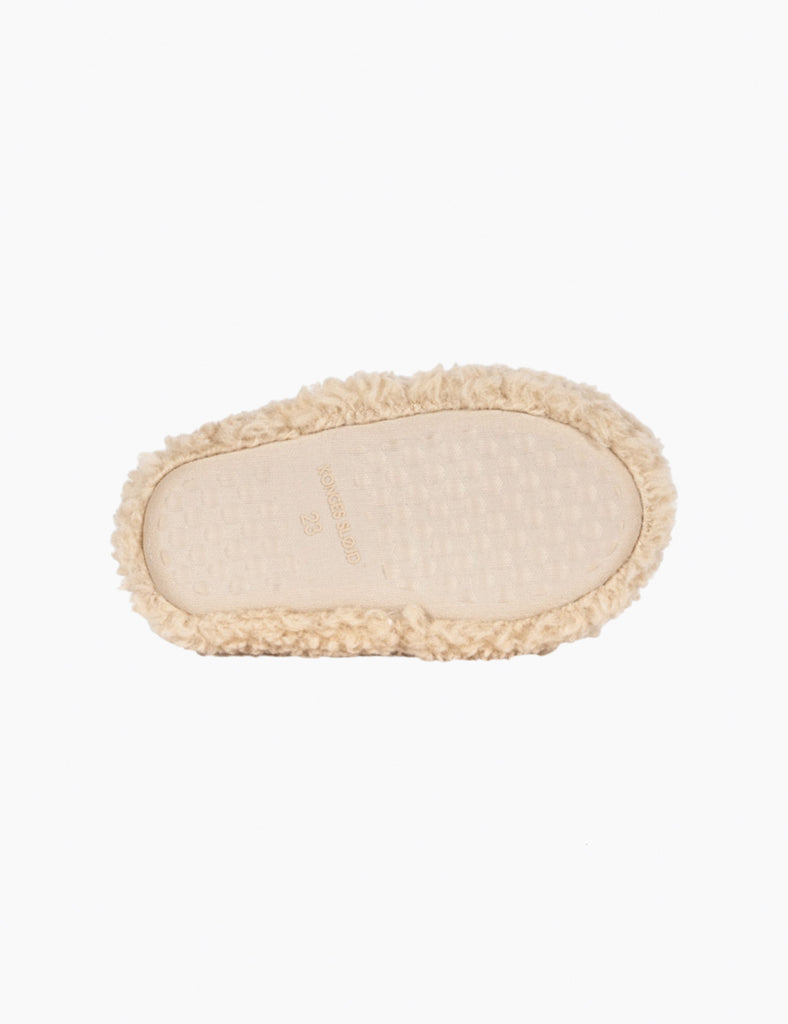 Beige slippers with fuzzy trim on a white background