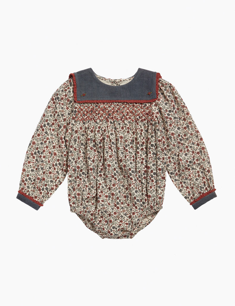 Floral baby romper with a dark collar on a white background