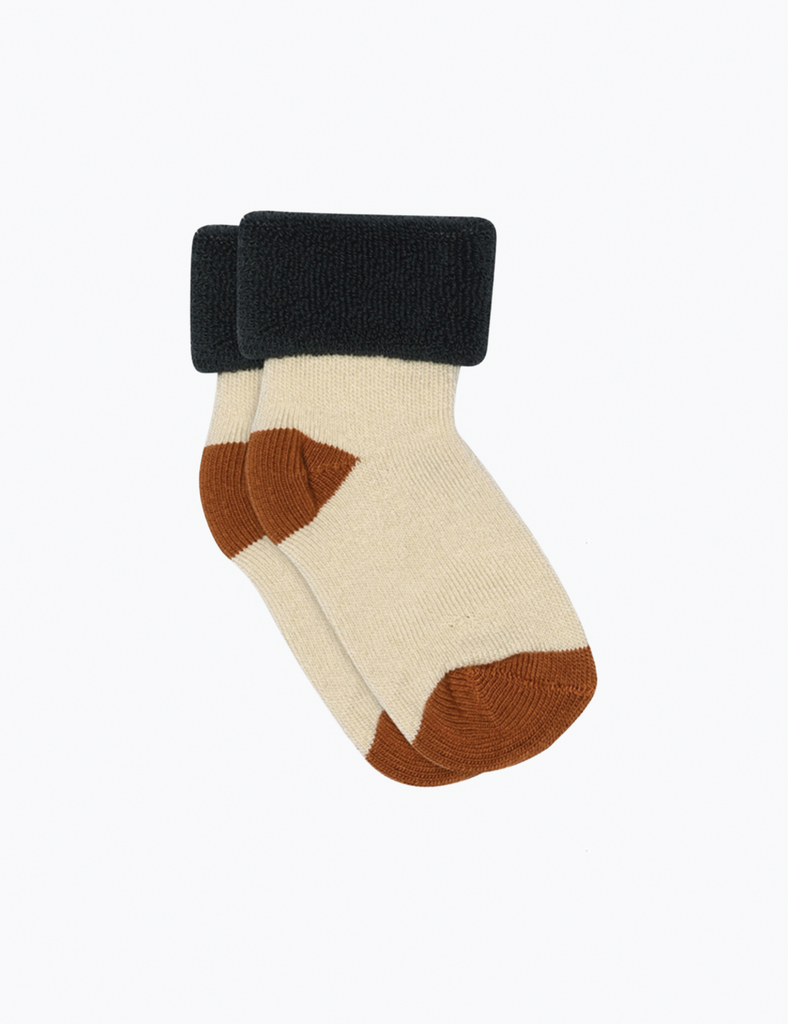 Beige and brown sock with black cuff on a white background
