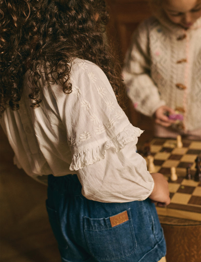 Two people playing chess in a warm, indoor setting.