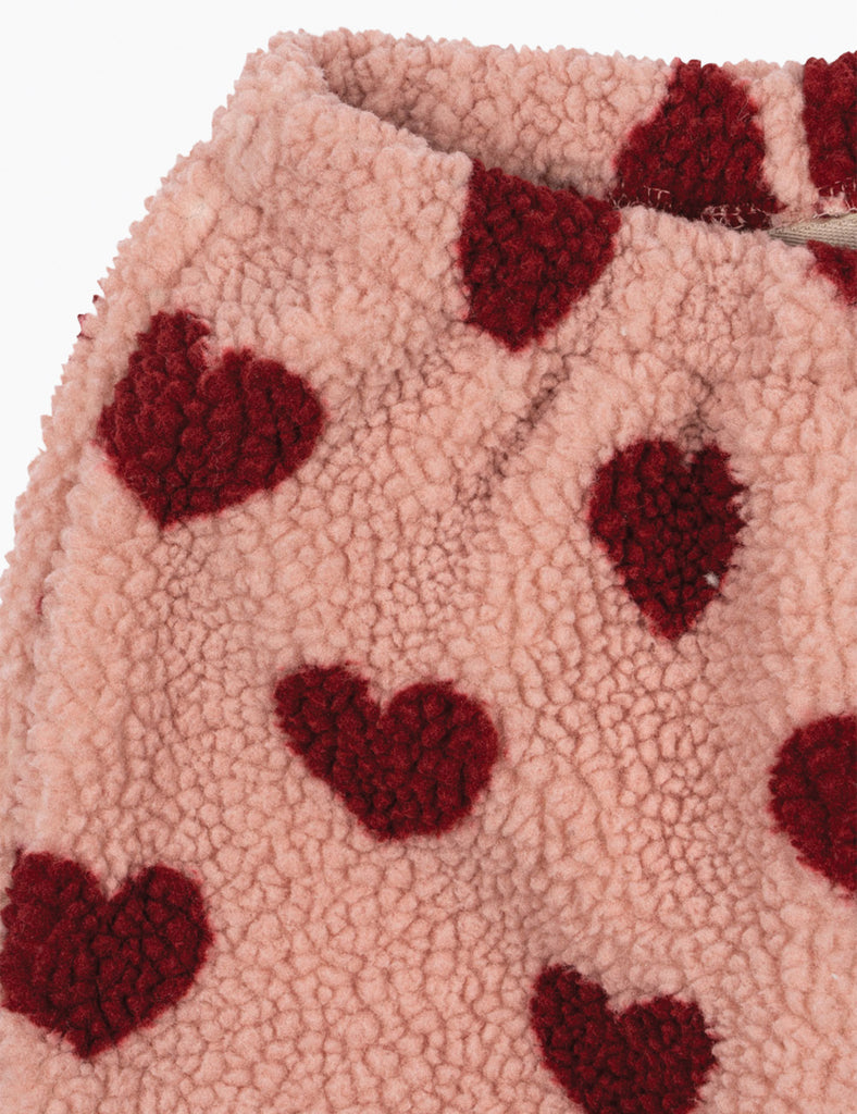 Close-up of pink fabric with red heart patterns