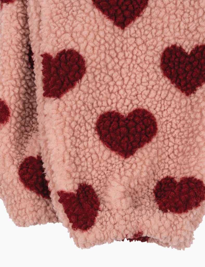 Close-up of pink fabric with red heart patterns