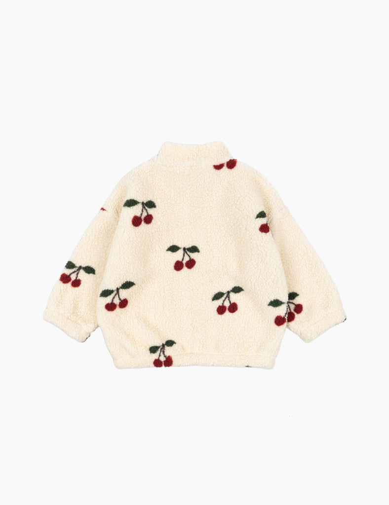 Cream-colored sweater with cherry pattern on a white background