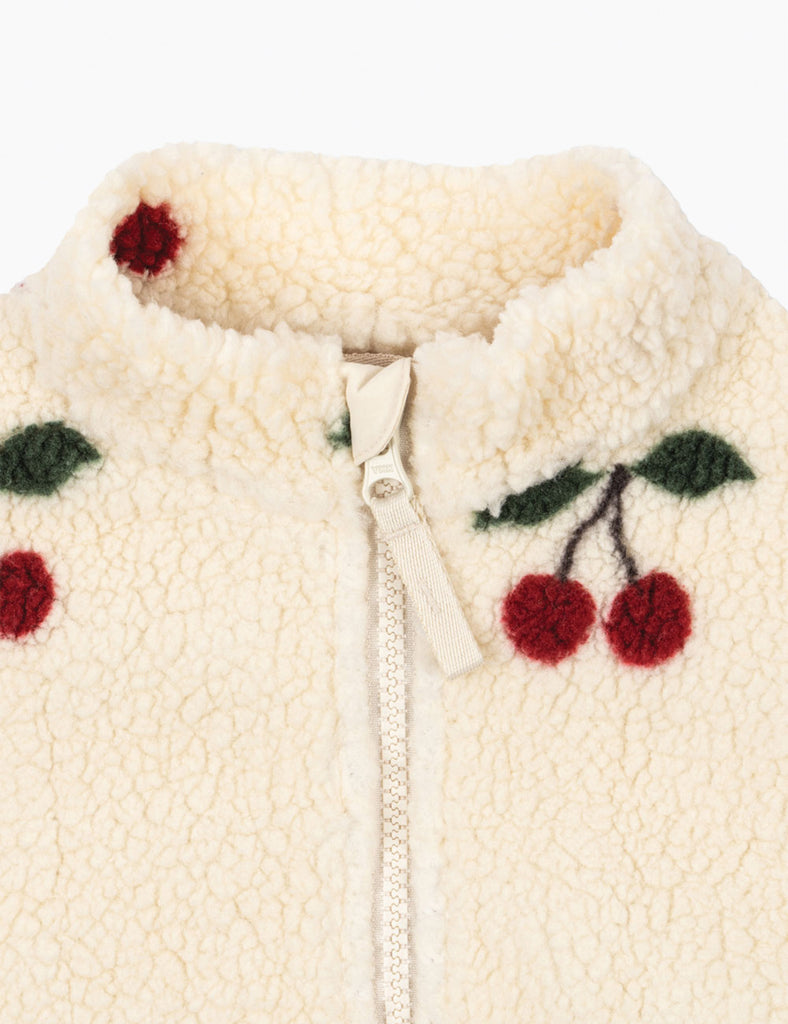 Cream-colored fleece jacket with cherry designs on a white background