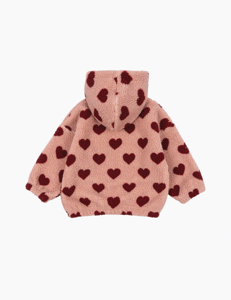 Pink fleece hoodie with heart patterns on a white background