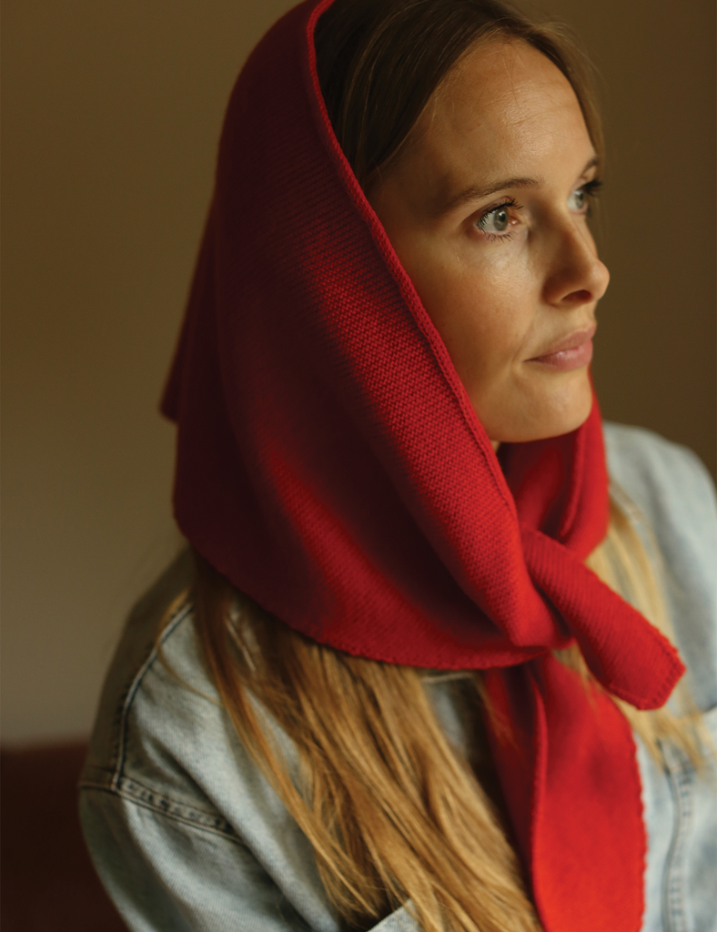 Woman wearing a red headscarf with a blurred background