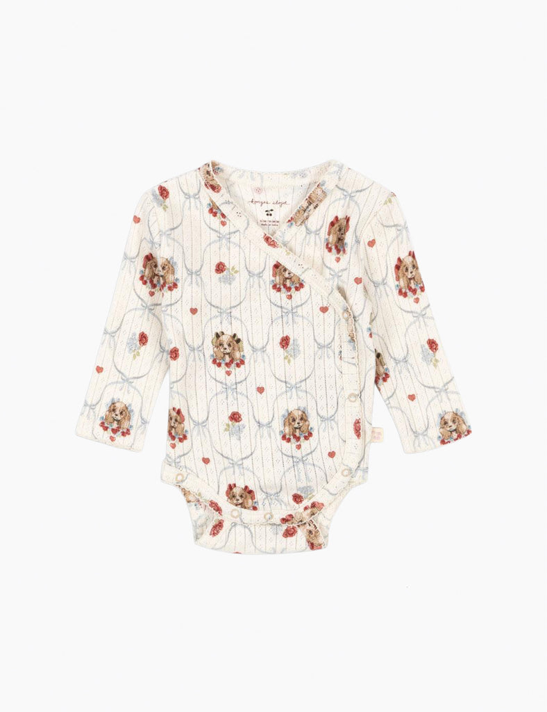 Puppy-patterned baby onesie on a white background