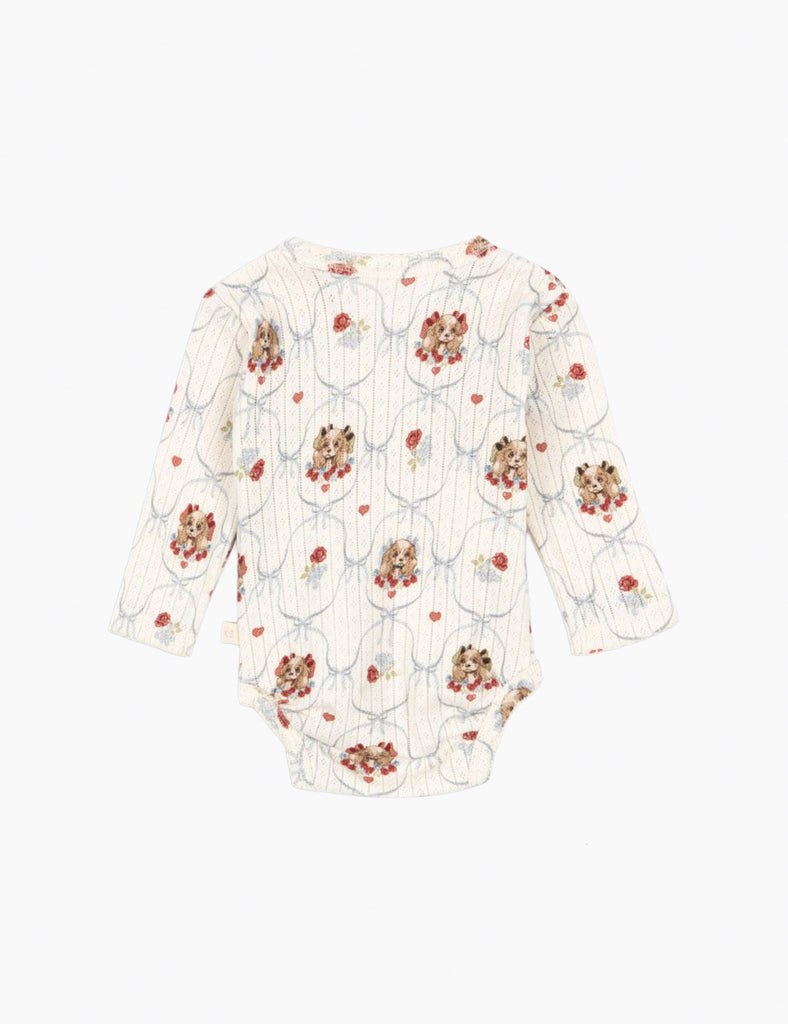 Puppy-patterned baby onesie on a white background