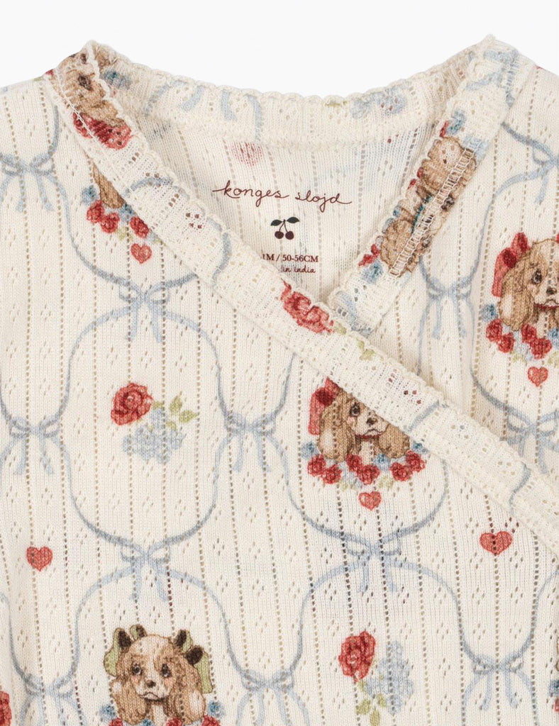 Puppy-patterned baby onesie on a white background