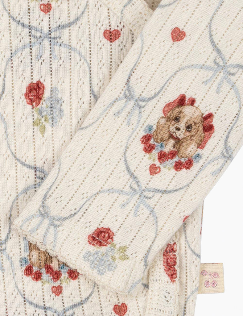 Puppy-patterned baby onesie on a white background