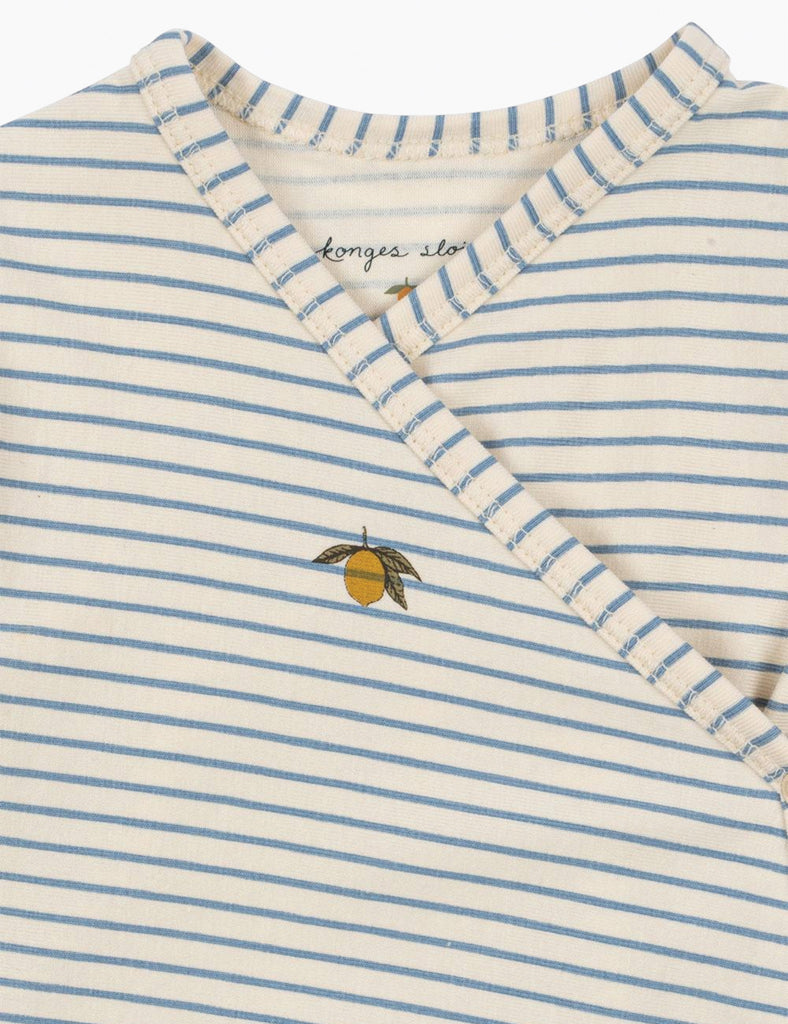 Close-up of a baby outfit with blue and white stripes and a lemon design on a white background.