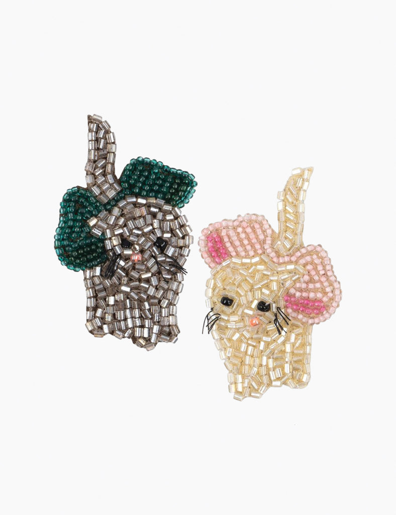 Two decorative hand beaded kitty hair clips on a heart-shaped card with a bow.