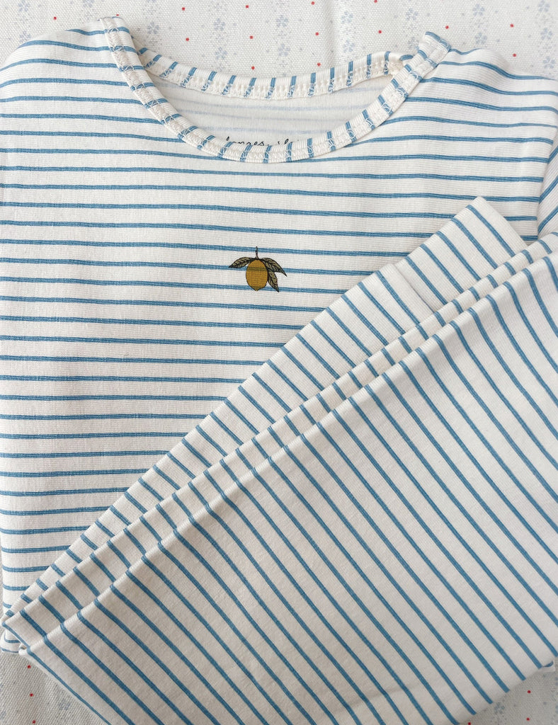 Striped shirt with a small embroidered design on a textured surface
