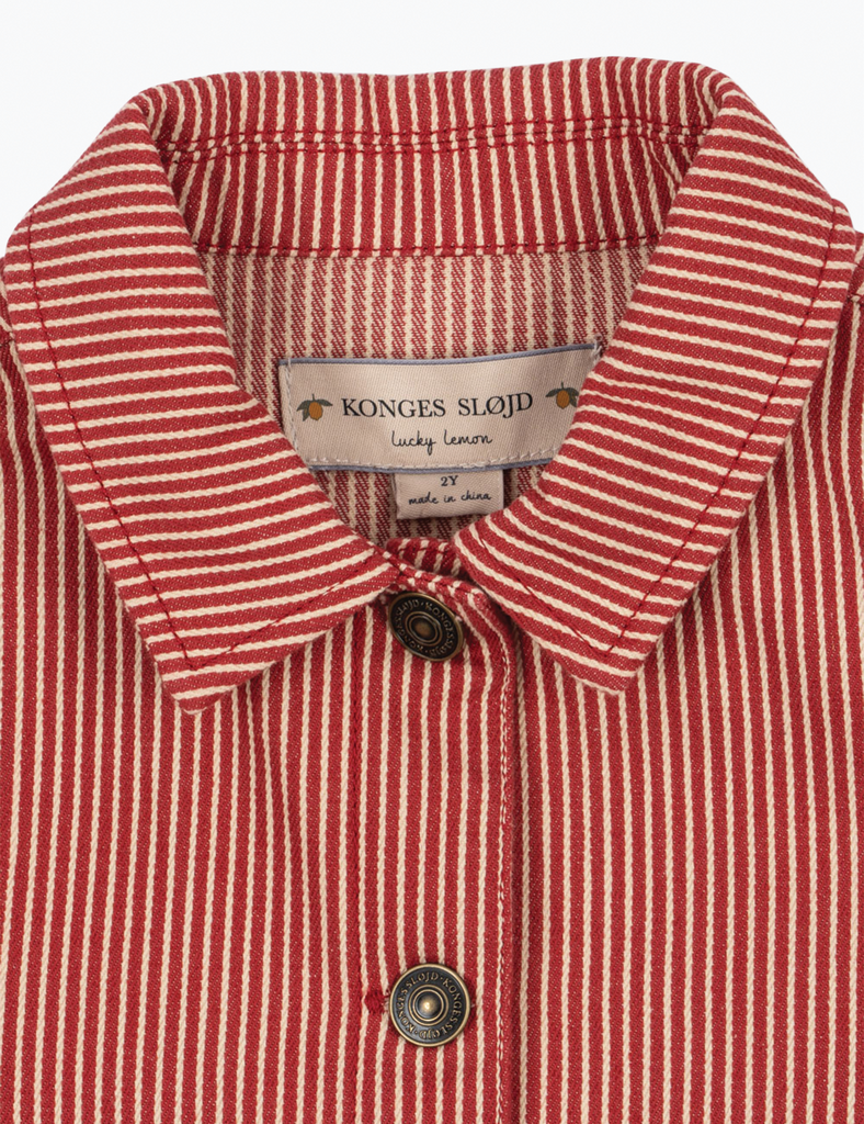 Close-up of a red and white striped shirt with a Konges Slojd label.