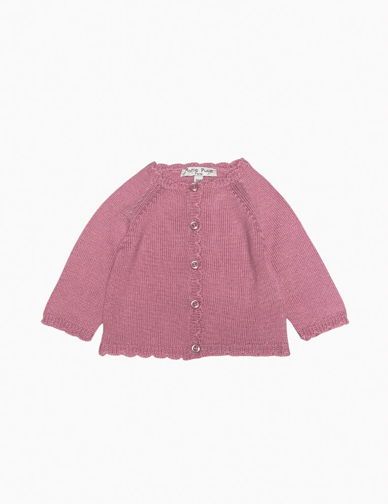 Pink knitted cardigan on a white background