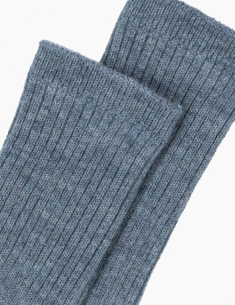 Pair of blue ribbed socks on a white background