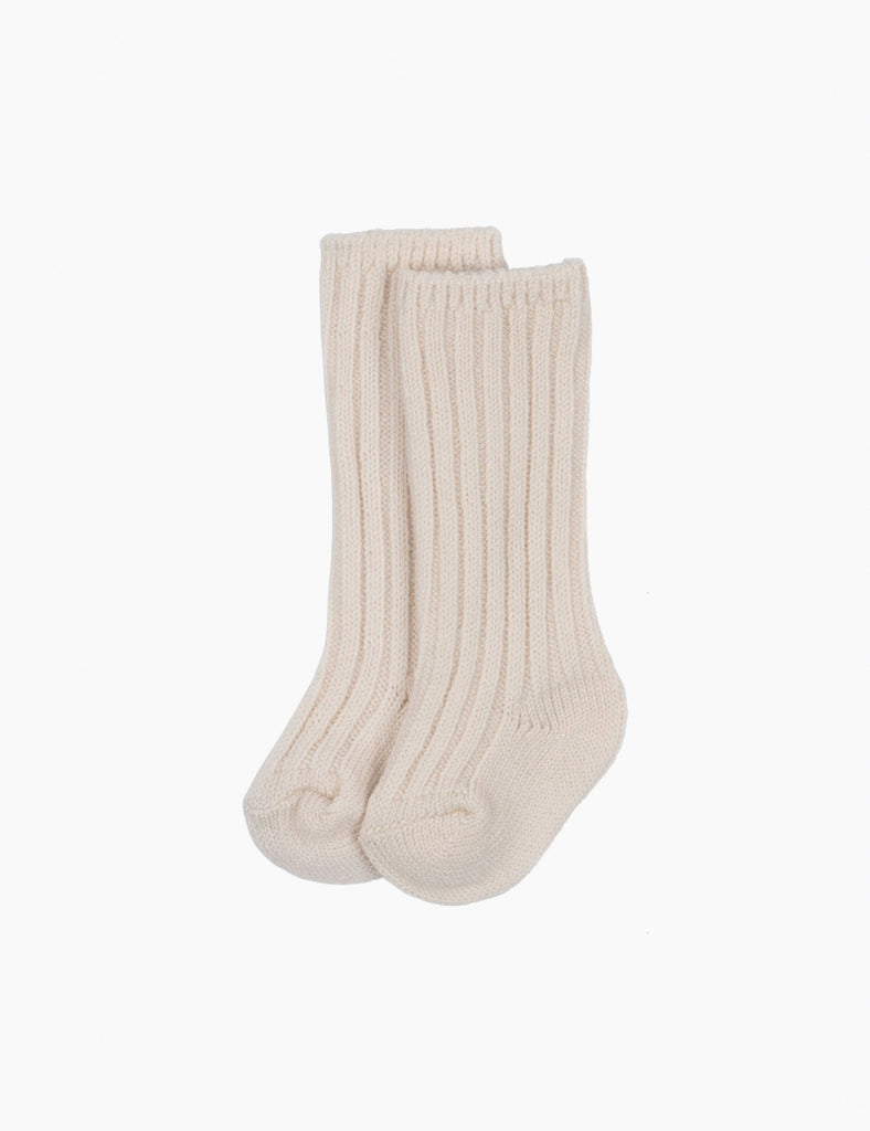 Pair of beige ribbed knee-high socks on a white background