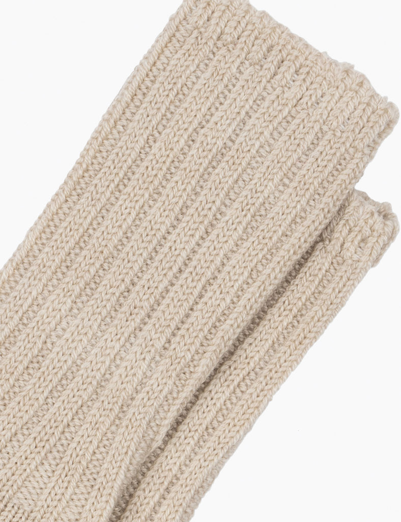 Close up of heavy knitted baby socks on a white background