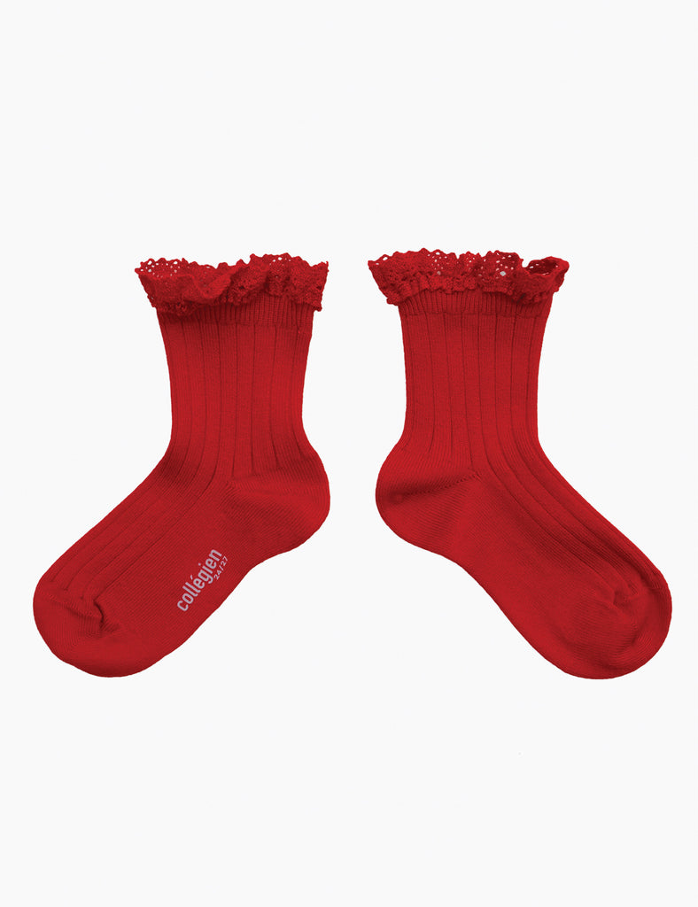 Pair of red socks with lace trim on a white background