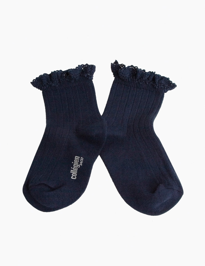 Pair of navy blue socks with ruffled top on a white background