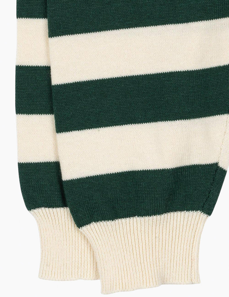 Close-up of a green and white striped sweater sleeve on a white background