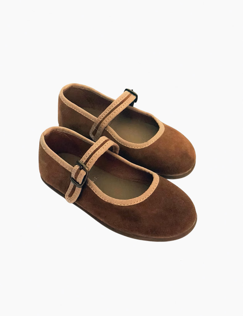 Image of Mary Janes in a camel suede color on a white background.
