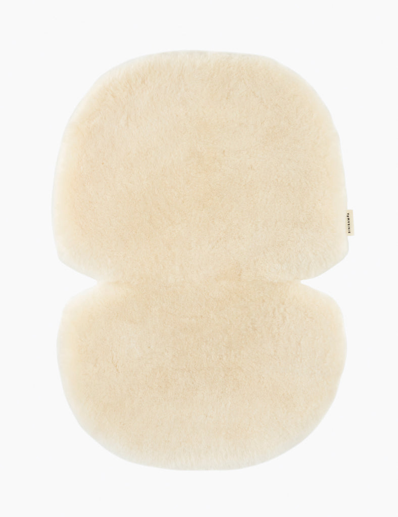 Soft off white stroller liner on a white background.
