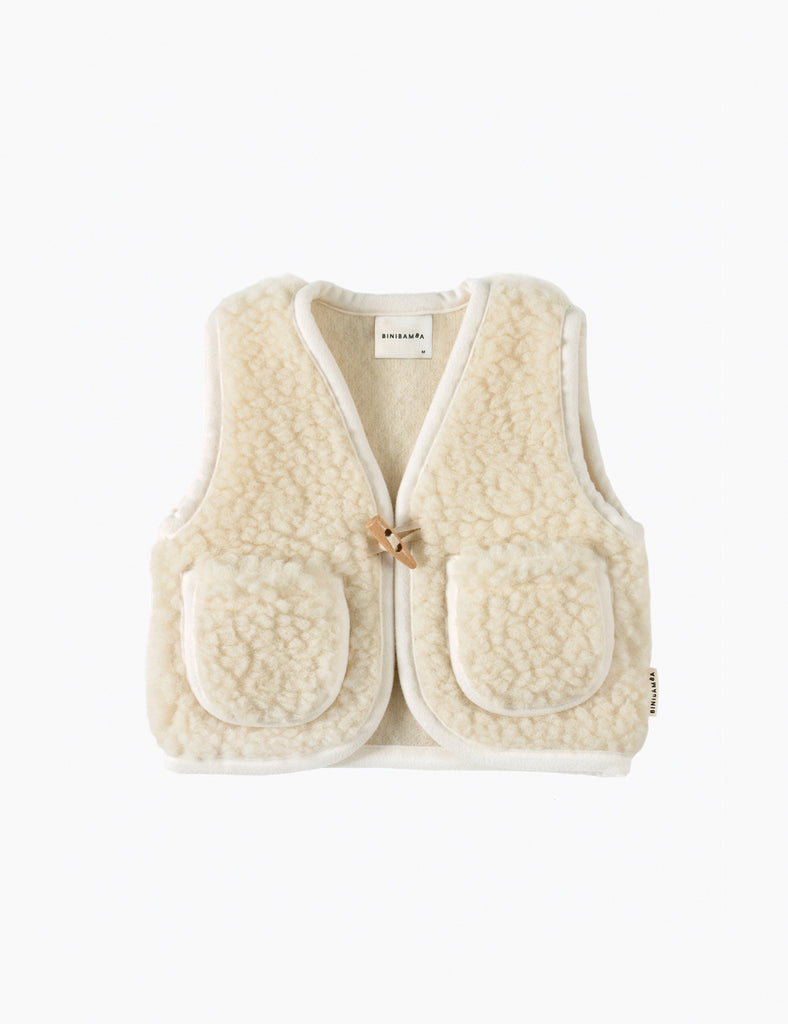 Cream-colored vest with a button on a white background