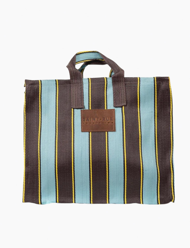 Image of a striped bag with leather branding on a white background