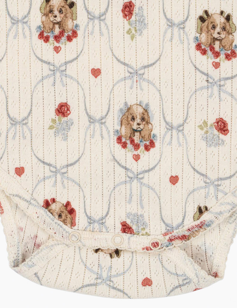 Baby romper with teddy bear and rose pattern on a white background