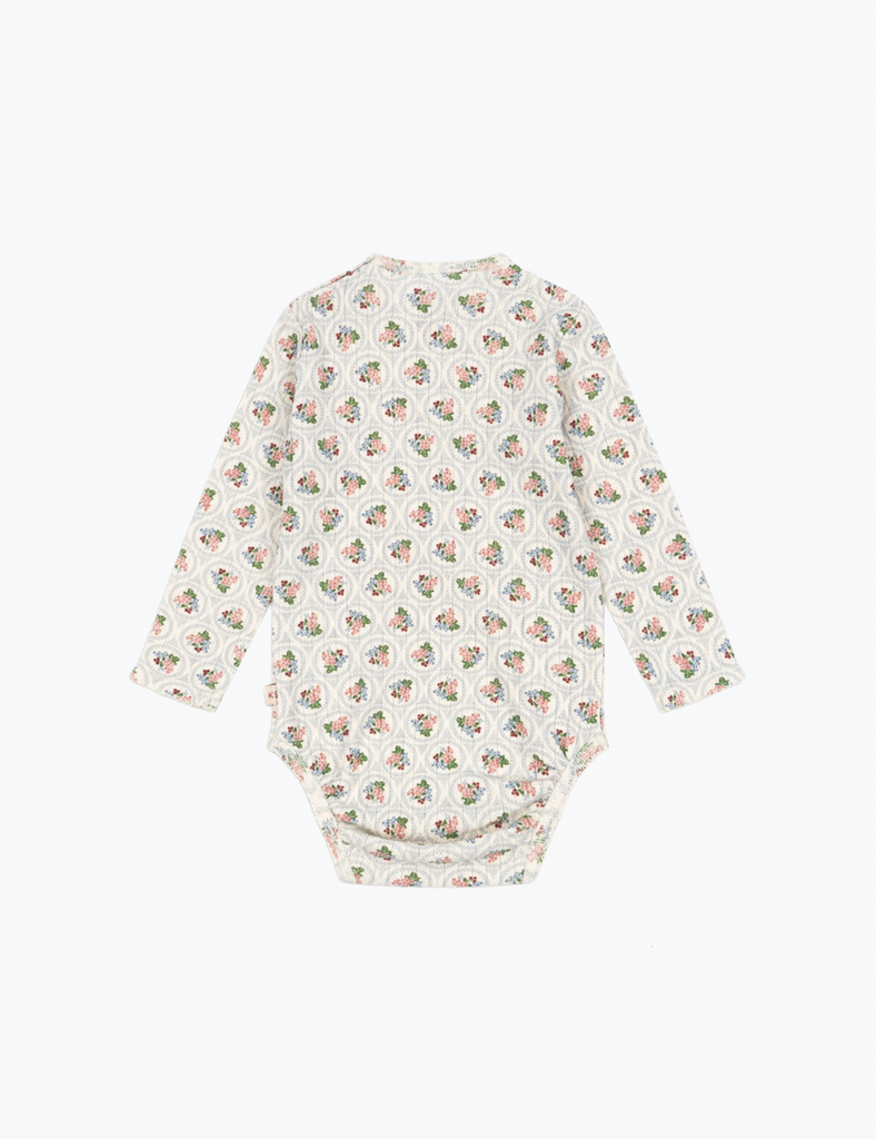 Baby onesie with a floral pattern on a white background