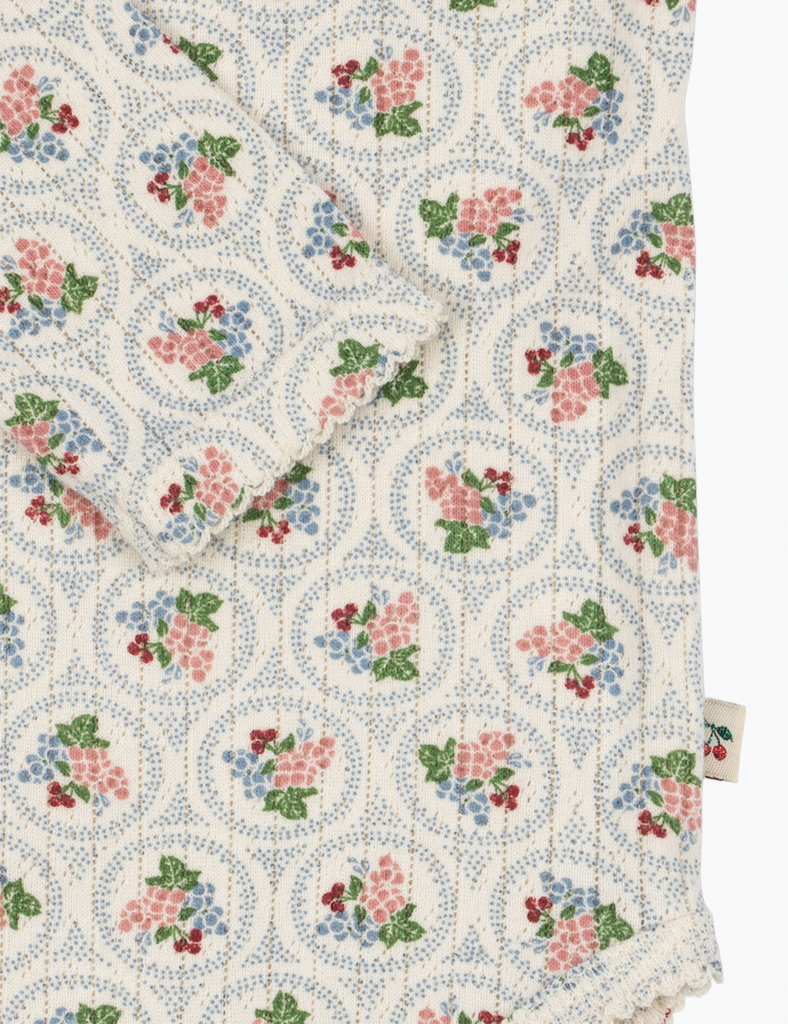 Floral patterned fabric with a small tag on a white background