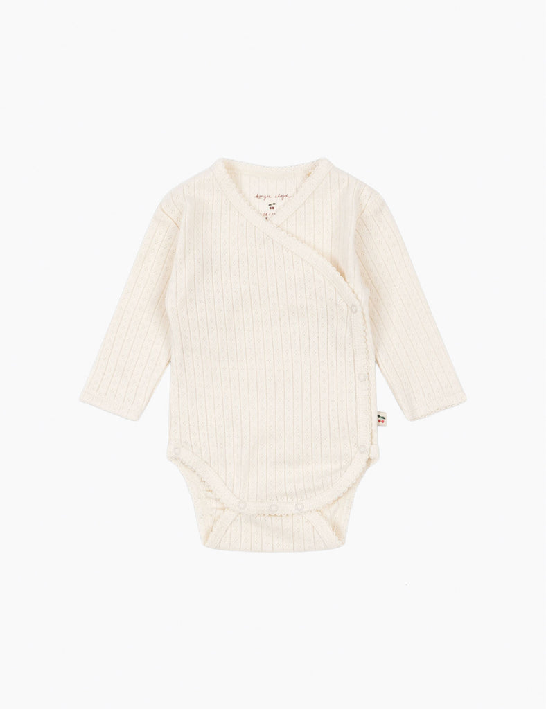 Beige baby bodysuit on a white background