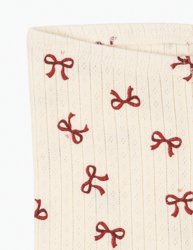 Beige fabric with red bow pattern