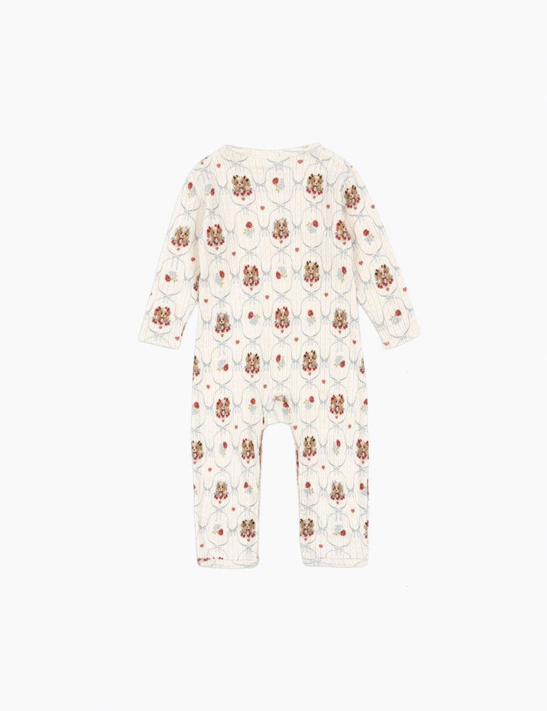 White baby onesie with puppypattern on a white background