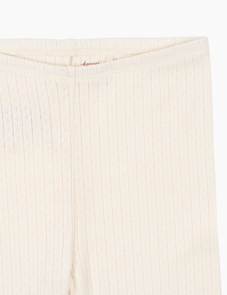 Close-up of a textured beige fabric with a subtle pattern on a white background