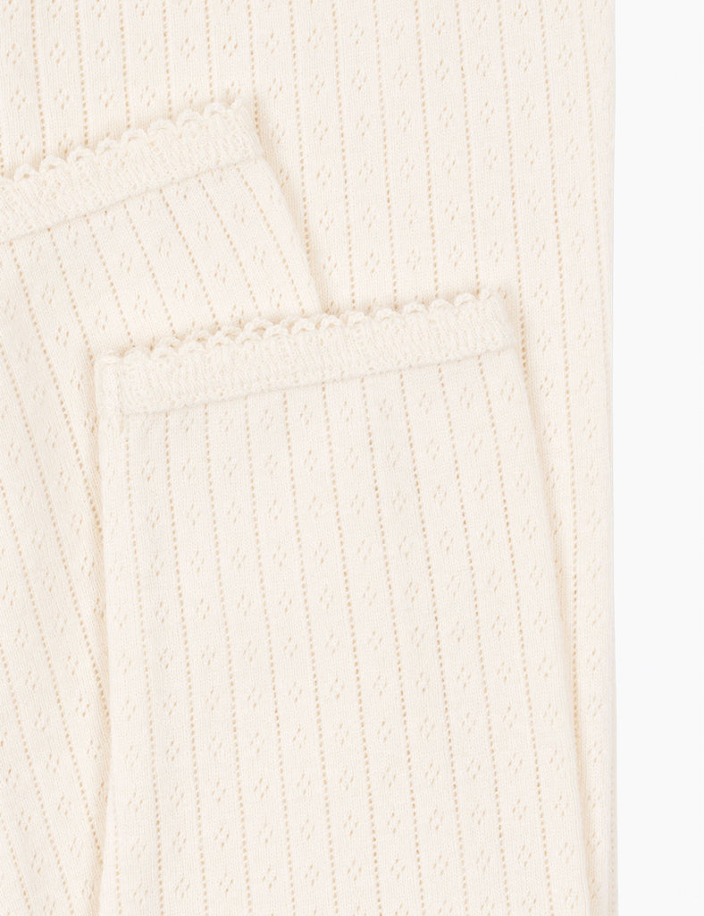 Close-up of a textured white fabric with a subtle pattern