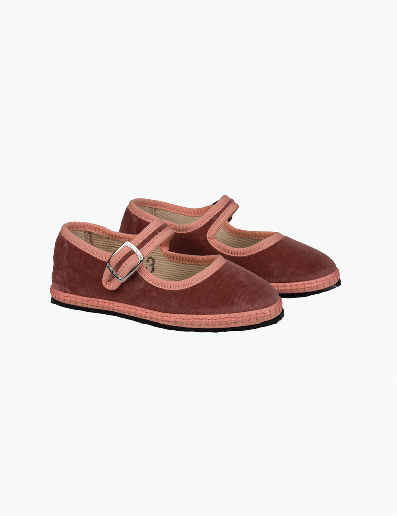 Pair of brown shoes with pink straps on a white background