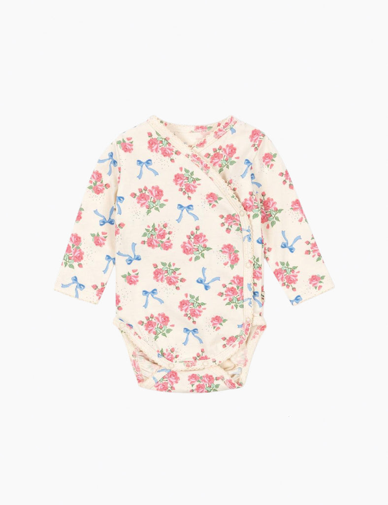 Floral baby romper with blue bows on a white background