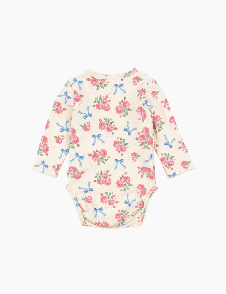 Floral and bow-patterned baby onesie on a white background