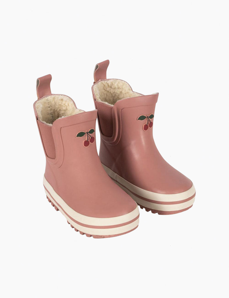 Pair of pink rain boots with cherry design on a white background