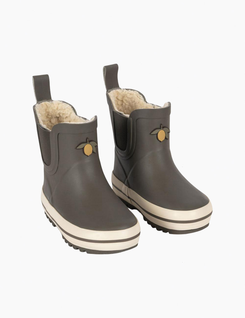 Pair of dark olive rain boots with white soles on a white background