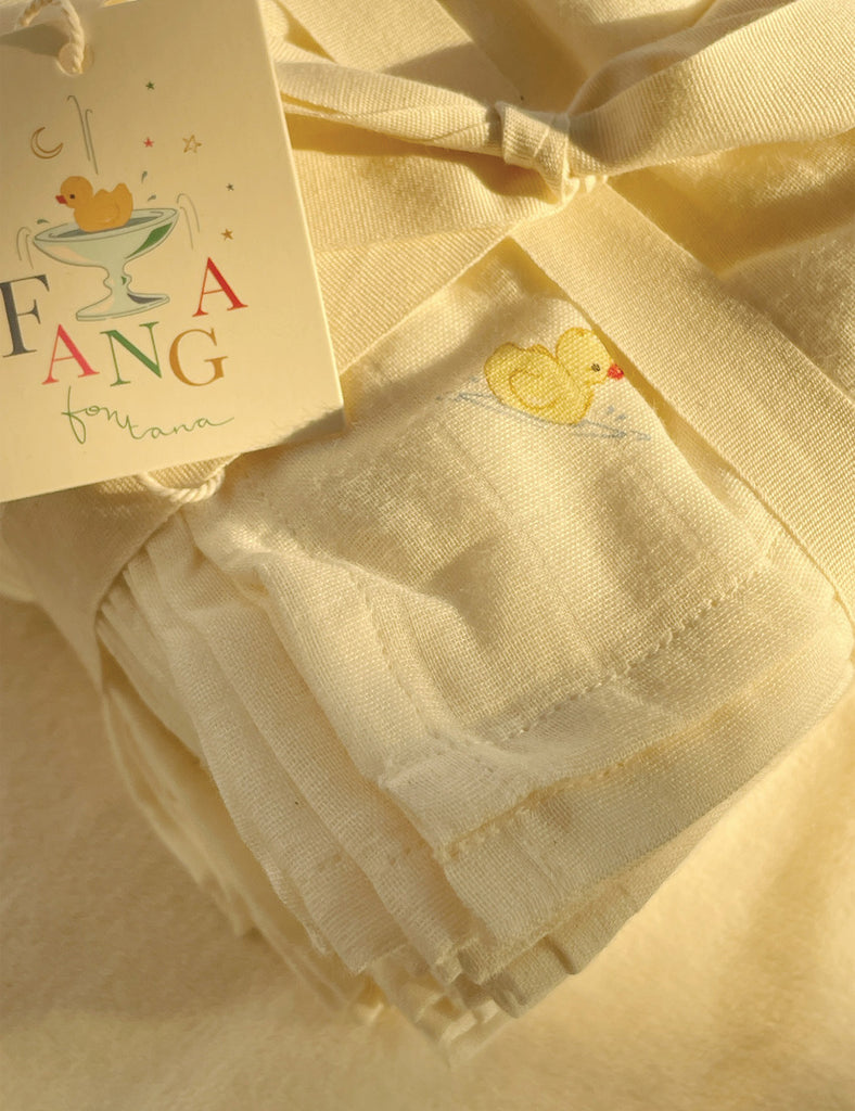 Stack of white baby burp cloths