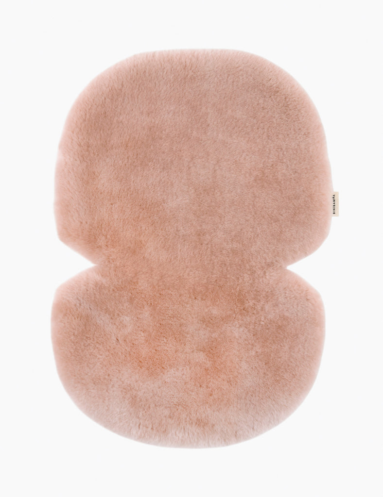 Fluffy pink stroller liner on a white background
