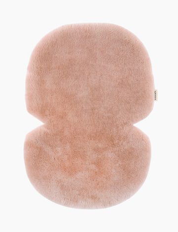 Fluffy pink stroller liner on a white background