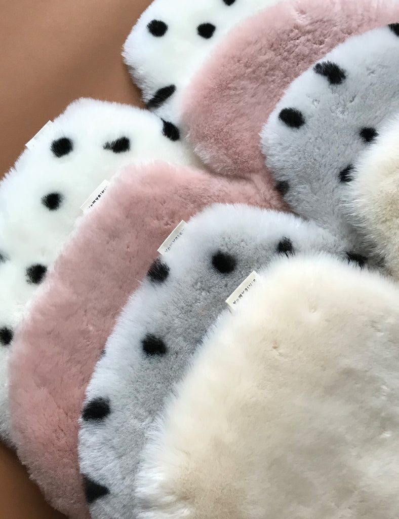 Close-up of all stroller liners on a tan background.