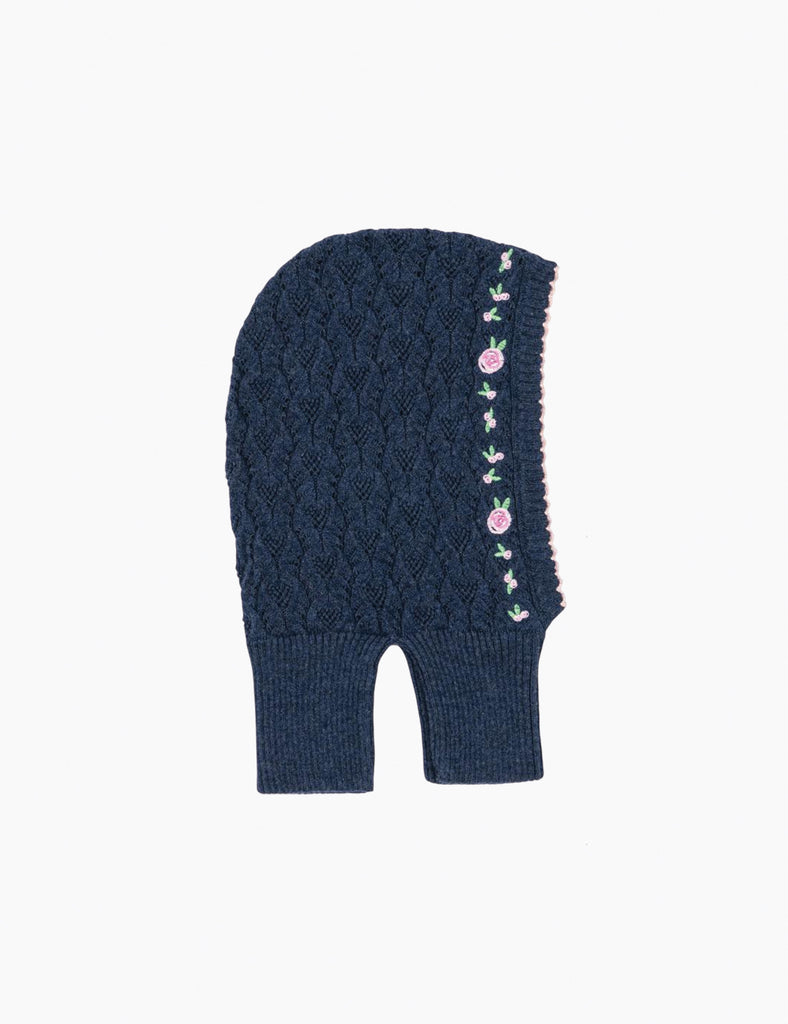 Image of knitted blue balaclava with embroidered roses on a white background.