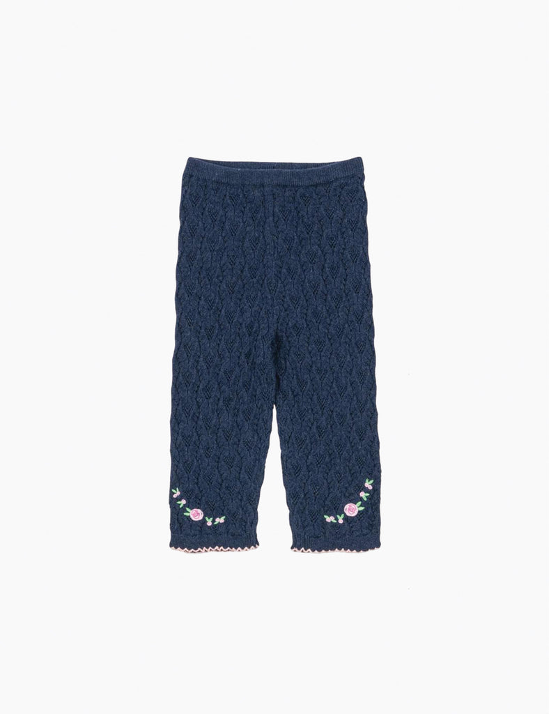 Navy blue textured pants with floral embroidery on a white background
