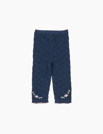 Navy blue textured pants with floral embroidery on a white background