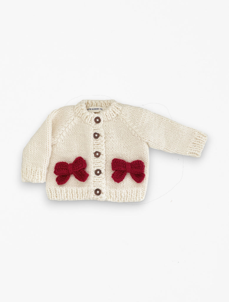 Red Bow Cardigan in Cream flat lay image.